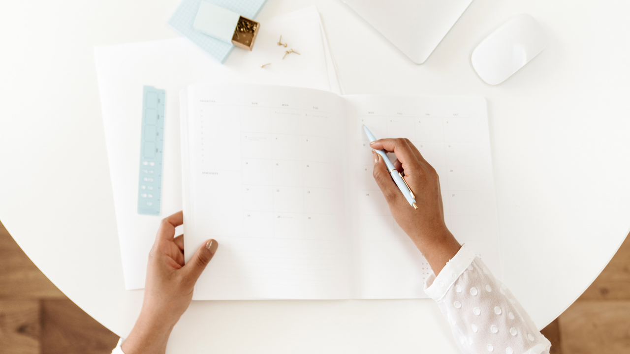 A woman noting something on a calendar